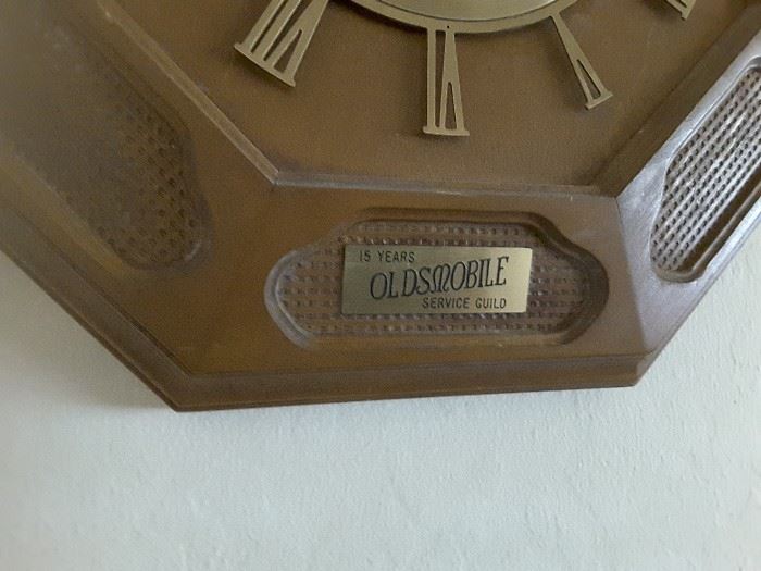 Close Up of Sign 15 Years Oldsmobile Service Guild on bottom of Elgin Wall Clock