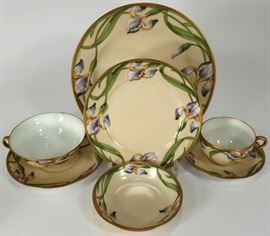 Large Lot of Walter Wilson "Purple Iris" Pattern Hand Painted Dinner Porcelain, E.20th C., includes oval platter, oval handled bowl, 12
teacups and saucers, 2 pairs of salt and pepper shakers, floral vase, tall handled vase inscribed "Mother's Day, 1935", rectangular
handled tray, oval platter, creamer and lidded sugar containers, 8 soup bowls and saucers, gravy boat with ladle, 8 small bowls, 12
dessert and dinner plates, handled tray, bowl and plate, various makers marks to undersides