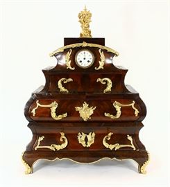 French Regency Mahogany Three Drawer Mantle Cabinet Clock with ormolu (gilt bronze) trim and cherub top with clock insert. Clock
face dial reads "Burgess, Angers"