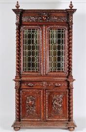 Renaissance Revival Oak Bookcase / Cupboard Late19th c. Upper cabinet has leaded stained glass doors, lower cabinet door panels carved motifs of Art & Architecture.