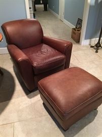 Two Pottery Barn leather chairs and one ottoman