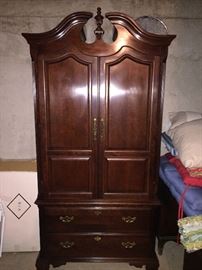 Thomasville wardrobe/studded for an entertainment center with a small hole and outlet