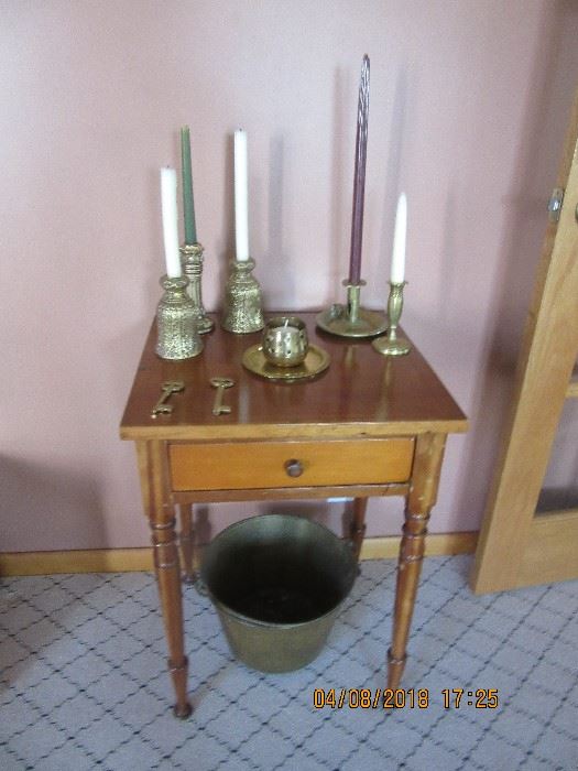 One of the one drawer stands in the home.  Under the table is a brass bucket from Meriden, Conn.  