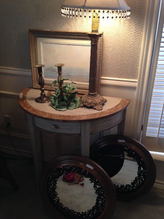 Demilune table; decorative lamp; small round mirrors