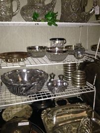 Serving pieces in glass, silver plate, and pewter