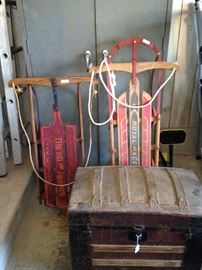 Sleds and an old round top trunk