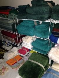An abundance of towels, place mats, napkins, and other  linens