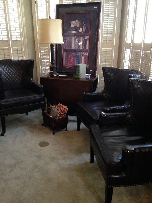 Three of four brownish/black leather chairs