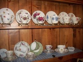 Cup and saucer collection in China cabinet
