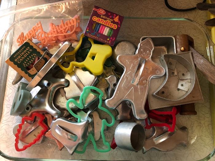 Pyrex Large baking pan filled with assorted cookie cutters