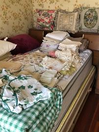 Assorted linens and full size bed