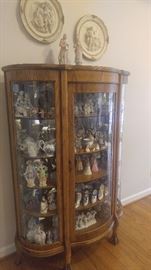  Antique oak radius china cabinet filled with vintage figurines and limoge Cobalt