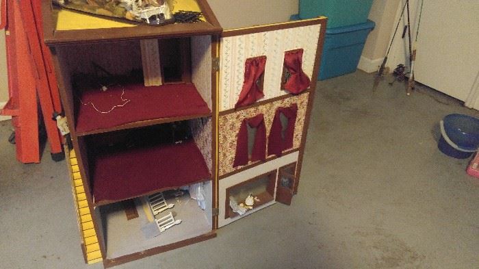 Three story dollhouse with lights people and furniture