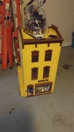 Three story dollhouse with lights people and furniture