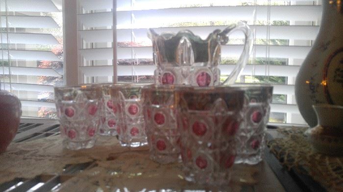Early king's crown type pitcher and glasses cranberry and 22 karat gold thumbprint