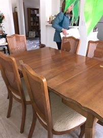 This dining table folds down to become a credenza type table. It has 3 leaves, two of which are in and pads.