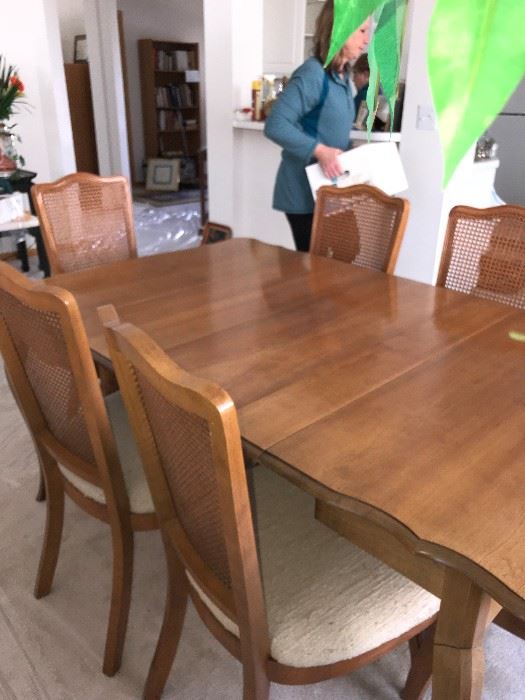 This dining table folds down to become a credenza type table.  It has 3 leaves, two of which are in and pads.