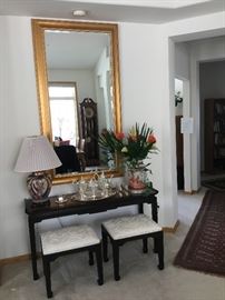 Lg gold framed mirror, 3 feet wide over an Ethan Allen table with 2 black lacquer stools with upholstered seats