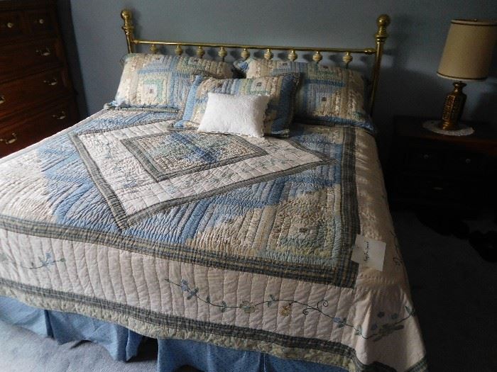 King  size  bed,brass  headboard  and  quilt.  (the  king  is  two  twins)