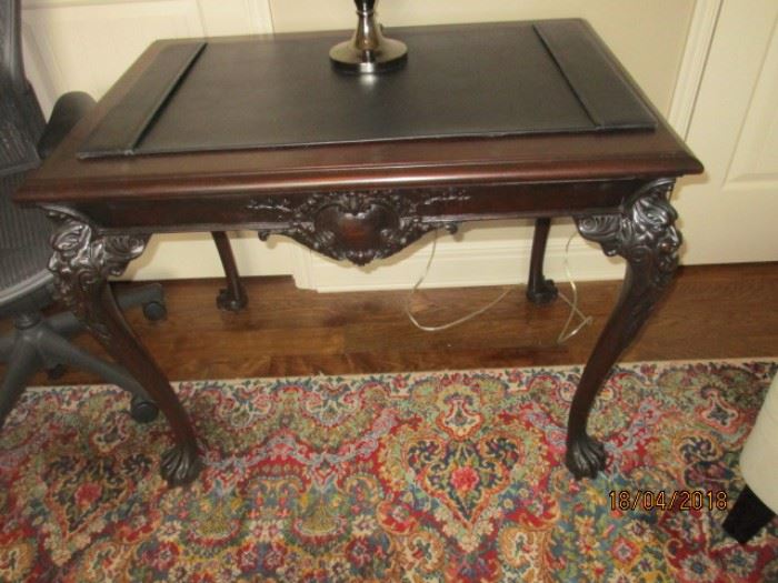 Antique Cavalier library table with carved heart, and claw feet