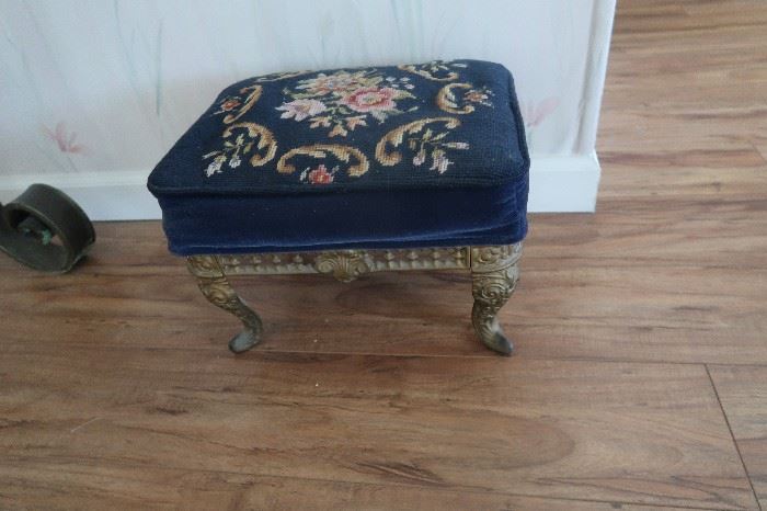 Needle point foot stool with Metal base.