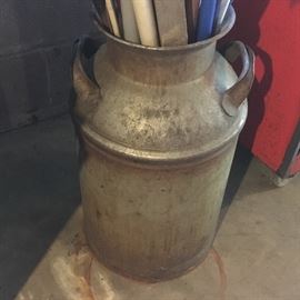 One of 2 old metal milk cans.