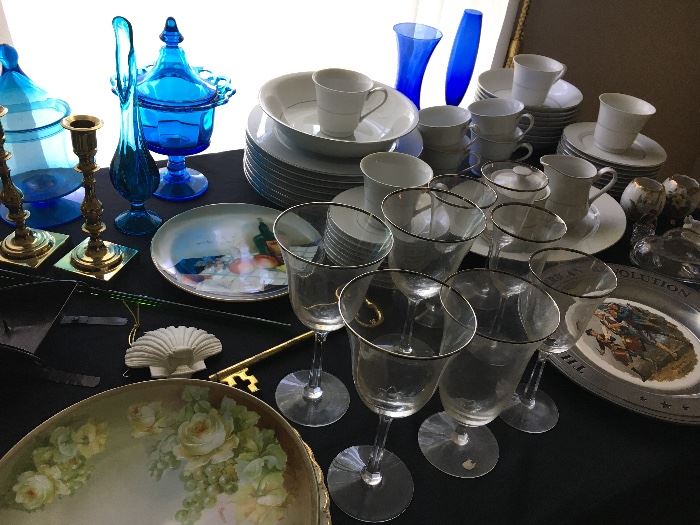 Tables full of kitchen and household items, decor, china and glassware.