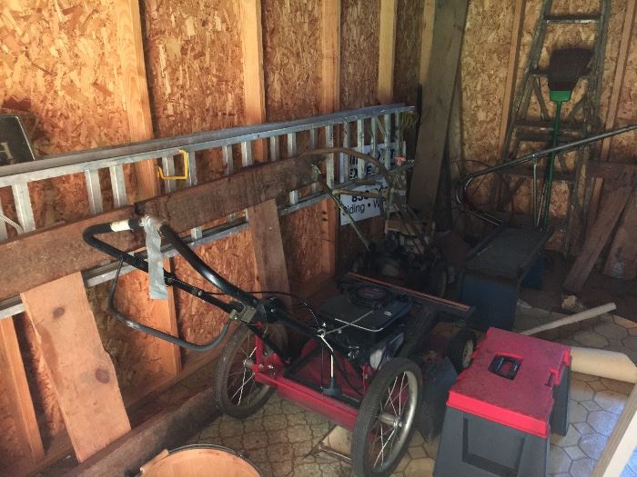Garage and shed items--ladders, lawnmower, saw horses.