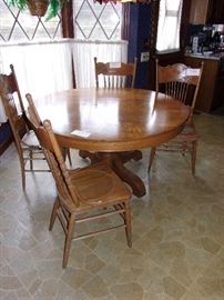 Antique oak round 54” dining table. 2 pairs matched chairs