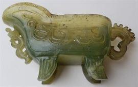 Chinese Archaic Form Carved Jade Beaker
Jade, serpentine or stone, Qing or Republic era, handled, footed and reticulated wine pitcher.
4.25 x 8 x 2.25 inches.