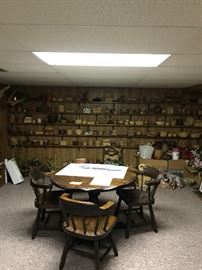 Wall shelves full of wicker baskets, boxes filled with good quality artificial flowers and greenery.
Heavy duty vintage round table with four chairs. I framed Signed Maynard Reece painting.