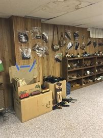 Lionel Train in box, misc leather gear for guns and knives on wall. Zoom in on the shelves, you will see wooden Duck and Fish carvings! Some signed by the artist!