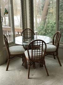 Glass top, Rattan table and four chairs! Excellent condition and quality piece!