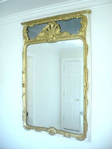 Large gold gilded hallway mirror.