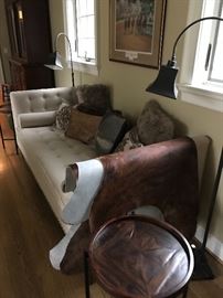 All Arhaus pieces: Clancy Daybed, cowhide rug, Carson floor lamps,  two Palencia round tables, and misc pillows 