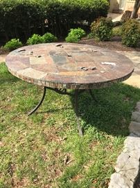 Large round tiled topped patio table.  Top has some damage.  