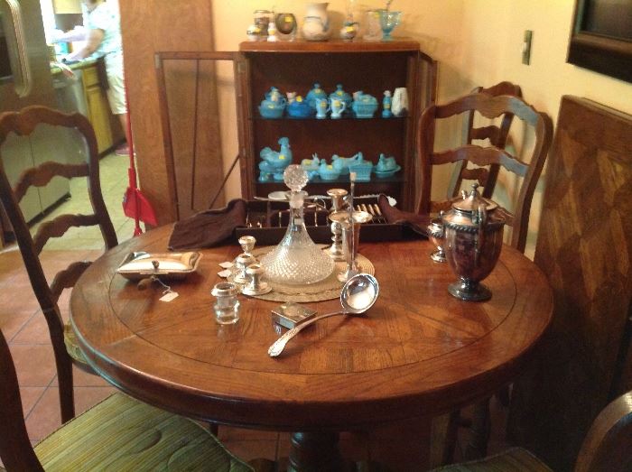 Silver items with milk glass in background