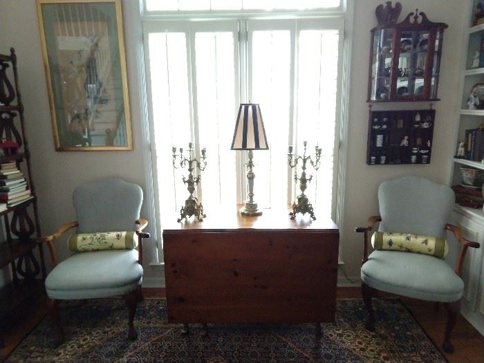 Vintage drop-leaf pine dining table, pair of upholstered wooden armchairs, pair of vintage brass 5-light candelabras, hanging shadow box collectibles, mirrored mahogany hanging curio cabinet and nicely framed/matted Asian artwork.