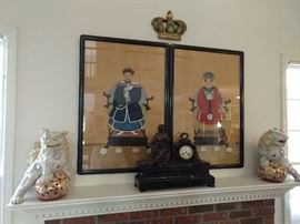 Pair of nicely executed Chinese ancestral portraits, on silk, flanked by a wonderful pair of porcelain foo dogs. French marble mantle clock in the foreground.
