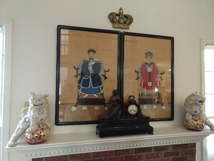 Pair of nicely executed Chinese ancestral portraits, on silk, flanked by a wonderful pair of porcelain foo dogs. French marble mantle clock in the foreground. 