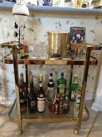 Vintage brass/glass tea cart, with all the requisite goodies that a bar cart should have.