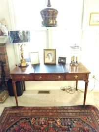 Wonderful Baker 3-drawer mahogany desk, with Asian gilt wood table lamp, vintage hanging brass swag lamp, French 3-light bouillotte lamp, all atop a vintage Persian Malayer hand woven rug.