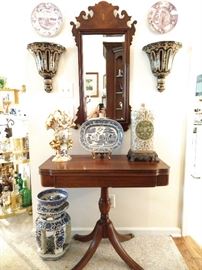 Vintage mahogany game table, with inlaid mahogany wall mirror, with beveled glass, pair of porcelain wall sconces, blue/white porcelain garden stool, English blue/white porcelain serving platter, green/cream Asian vase, with bronze mounts.