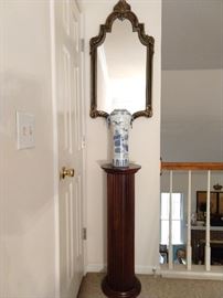 Fluted mahogany plant stand, with Asian blue/white porcelain vase and carved wood black/gold wall mirror. 