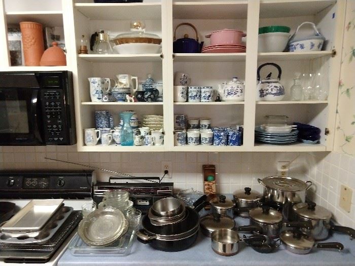 You'll find blue/white porcelain items throughout this house! Here's a few tucked away in the kitchen cabinets. Countertops filled with vintage, heavier Revere Ware pots, with lids, pie plates, muffin pans, cooling racks, etc.