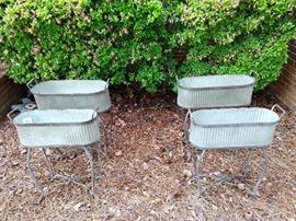 Two pair of graduated size galvanized tin flower planters.