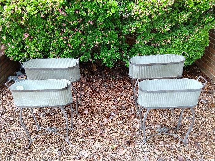 Two pair of graduated size galvanized tin flower planters. 