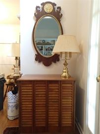 Hand made louvered door pine cabinet, 3-light brass table lamp, Henredon beveled glass mirror. 