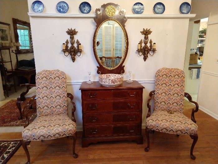 On plate rail: collection of 16 Bing & Grondahl (Copenhagen) plates, pair of flame stitched upholstered wooden armchairs, 4-drawer mahogany chest, Henredon mahogany beveled glass mirror, flanked by a pair of 2-light metal sconces.