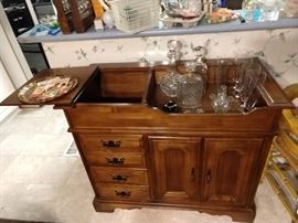 This dry bar has a trick - you can hide away your bottles of booze from your nosy partner or the revenuers!